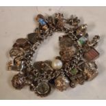 A silver charm bracelet, suspended with a variety of silver charms,