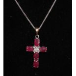 A ruby and diamond accented 9ct white gold cross pendant,
