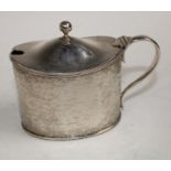 A Victorian silver oval tankard mustard pot, chased with delicate leafy trailing stems,