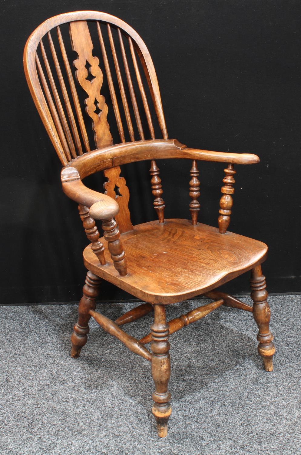 A Country House elm Windsor elbow chair, hoop back, pierced splat,