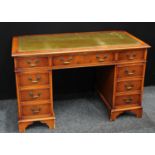 A George III style twin pedestal writing desk, rectangular top with inset writing surface,