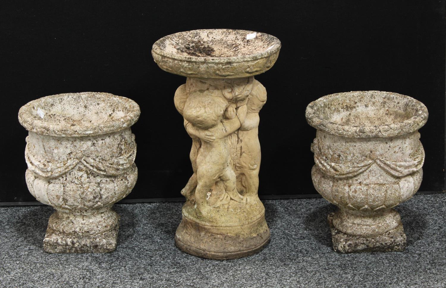 A pair of stone campana shaped garden urns, 32.