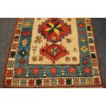 A Persian style handwoven rug, decorated with geometric motifs in bright colours, 138cm wide,