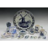 A large Delft wall charger; an earthern ware tile; other souvenir Delft trinkets, clogs,