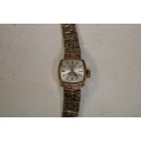 A lady's 9ct gold rotary wristwatch, square dial, baton indicators, integral 9ct bracelet strap,