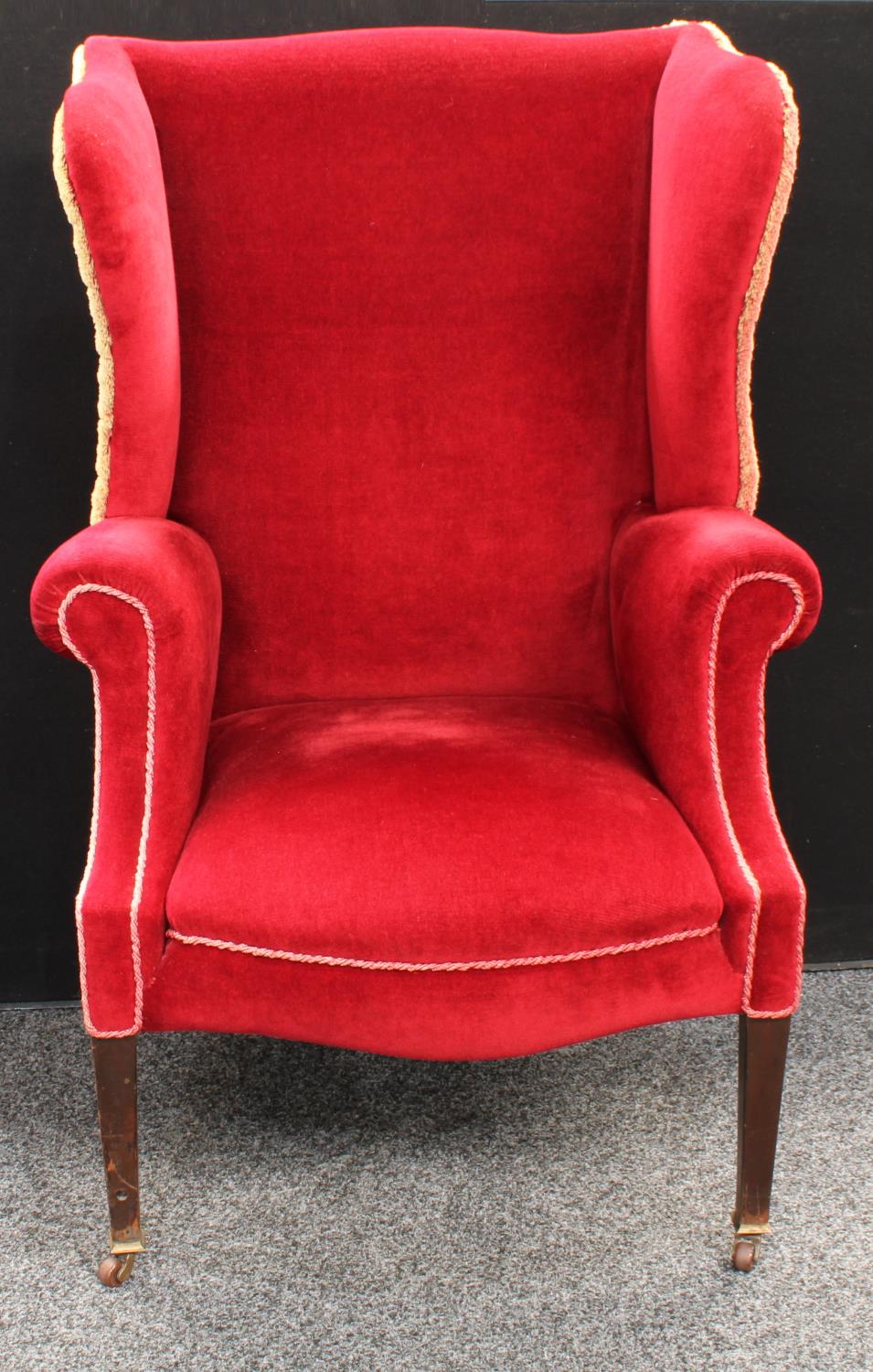 An early 20th century wingback armchair, scroll arms, stuffed over upholstery, 118. - Image 4 of 4