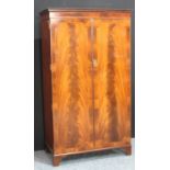 A flame mahogany double wardrobe,