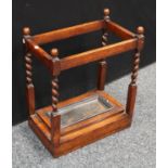 An oak walking stick/umbrella stand, barley twist supports,