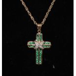 A 9ct gold diamond and pale green stone inset cross pendant necklace, stamped 375 dia, 4.