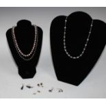 A cultured white and black pearl necklace; other single strand cultured pearl necklaces,