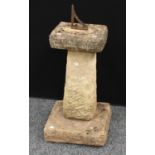 A reconstituted stone garden sundial, the gnomon fashioned from a bracket,