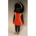 A vintage 1950/60's black pedigree doll, soft head, sleeping eyes, hard body, jointed limbs,