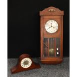 An oak wall clock, eight day, key and pendulum, 80cm; a London Clock Company mahogany mantel clock,