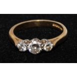 A diamond trilogy ring, central round brilliant cut diamond approx 0.