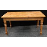 A Farmhouse pine country kitchen table, rounded rectangular top, turned legs, 152.