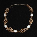 A white opal five panel fancy link naval knot rope bracelet, stamped 9kt to clasp, 18cm long,