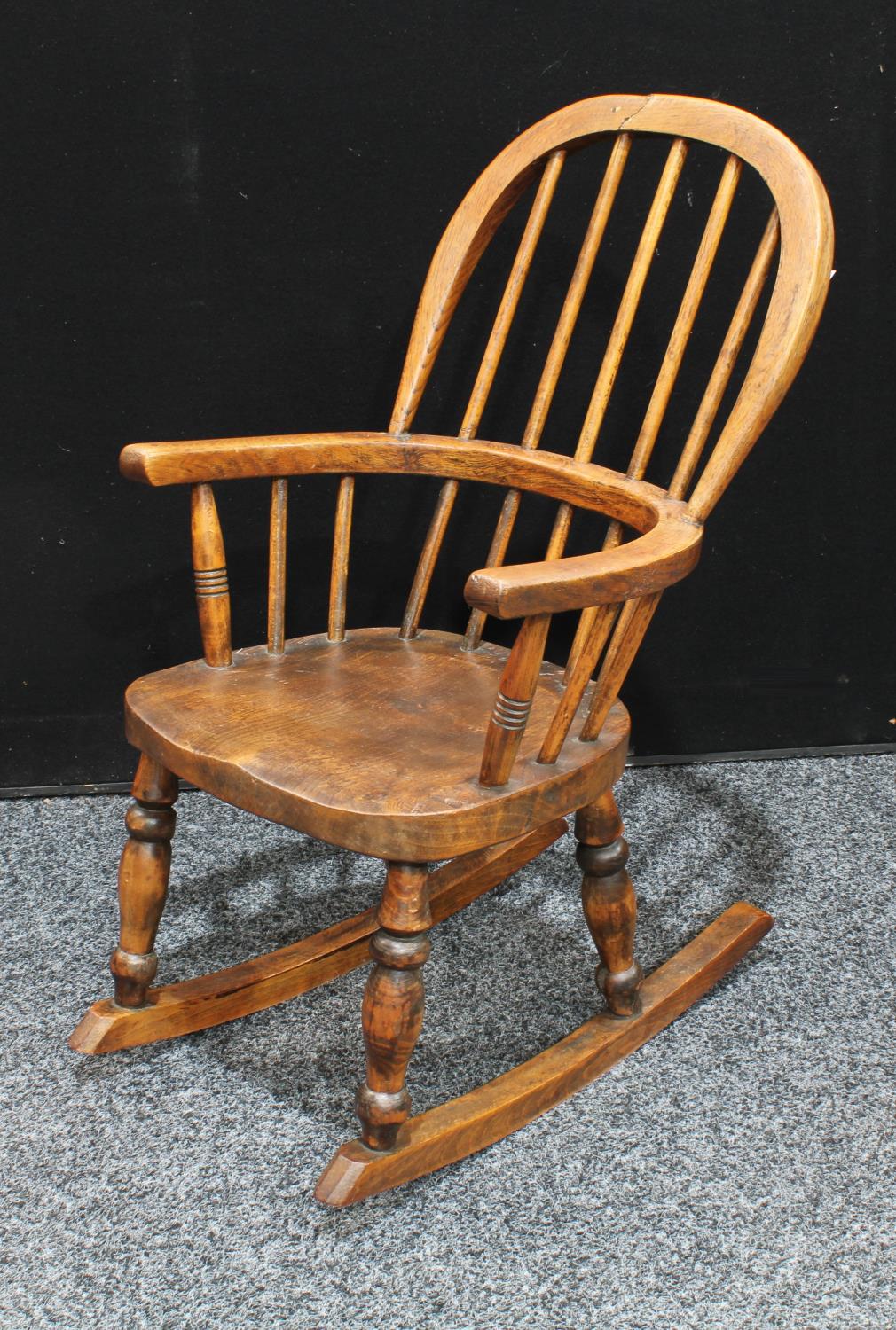 A Country House child's Windsor rocking chair, hoop back, bowed mid-rail, saddle seat,