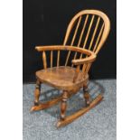 A Country House child's Windsor rocking chair, hoop back, bowed mid-rail, saddle seat,