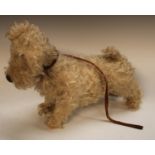 A 1940s Chiltern Toys Stuffed soft Terrier dog, modelled standing, legs stretching fore and aft,