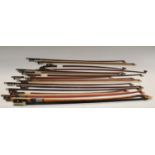 A collection of violin bows,