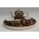A Royal Crown Derby Imari palette 1128 pattern miniature cabaret set on tray, comprising teapot,