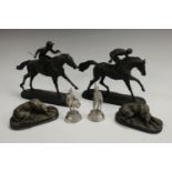A pair of desk weights as hounds; a pair of resin jockey models;