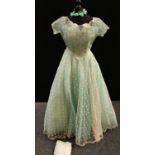 A mid 20th century evening gown and head dress, spotted cream net over turquoise underskirt,