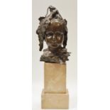 A bronze bust of a child wearing a bonnet, marble plinth. 34cm high (plinth 15cm high)