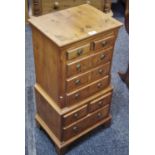A yew veneered chest on chest of small proportions, two short drawers over three long to top,