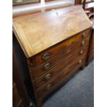 A George III mahogany bureau fall front enclosed fitted interior over four beaded and graduated