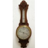 An early 20th century carved oak barometer