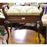 A late Victorian piano stool, turned side rails, padded hinged seat, carved French cabriole legs.