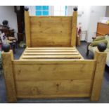 A designer hardwood bed 199cm long,