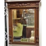 A French walnut wall mirror, ogee pediment, carved frieze,
