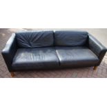 A black leather executive office sofa.