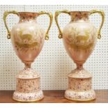 A large pair of 19th century blush pink and gilt twin handled baluster shaped vases on stands,
