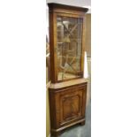 A reproduction walnut veneered floor standing corner cupboard,