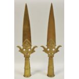 A pair of late 19th/early 20th century tall Far Eastern bronze ornamental spear heads decorated