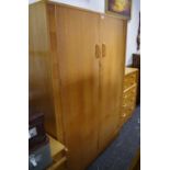 A light oak G-plan bedroom suite comprising double wardrobe dressing chest; five drawer chest;