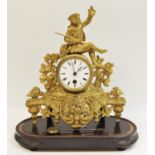 A 19th century French gilt metal mantel clock surmounted with an 18th century huntsman and