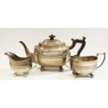 A silver three piece tea set, teapot, banded collar, ball feet,