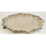 A silver Edwardian shaped circular tray, knurl feet, Barker Brothers, Chester, 1907,