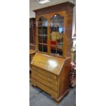 An Edwardian mahogany bureau bookcase, ogee cornice,
