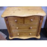 A pine chest, serpentine top, two short drawers over two long, turned feet.
