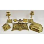 A pair of early 19th century brass rococo candlesticks;