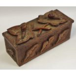 An Arts & Crafts carved oak tea caddy surmounted with carved ivy leaves and snail details,
