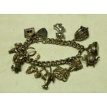 A silver charm bracelet and eleven charms,