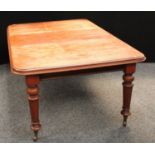 A Victorian mahogany extending dining table, rounded rectangular top with one additional leaf,