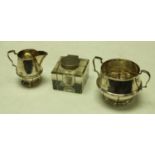 A silver milk jug and sugar bowl, stop fluted, scroll handles, 8cm, London 1923, 169.