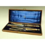 A late Victorian carving set, antler hafted, steel blades, silver mounted, Mappin and Webb,
